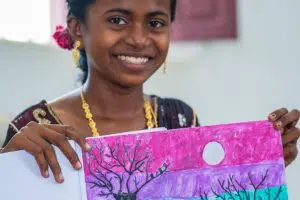 Girl holding painting