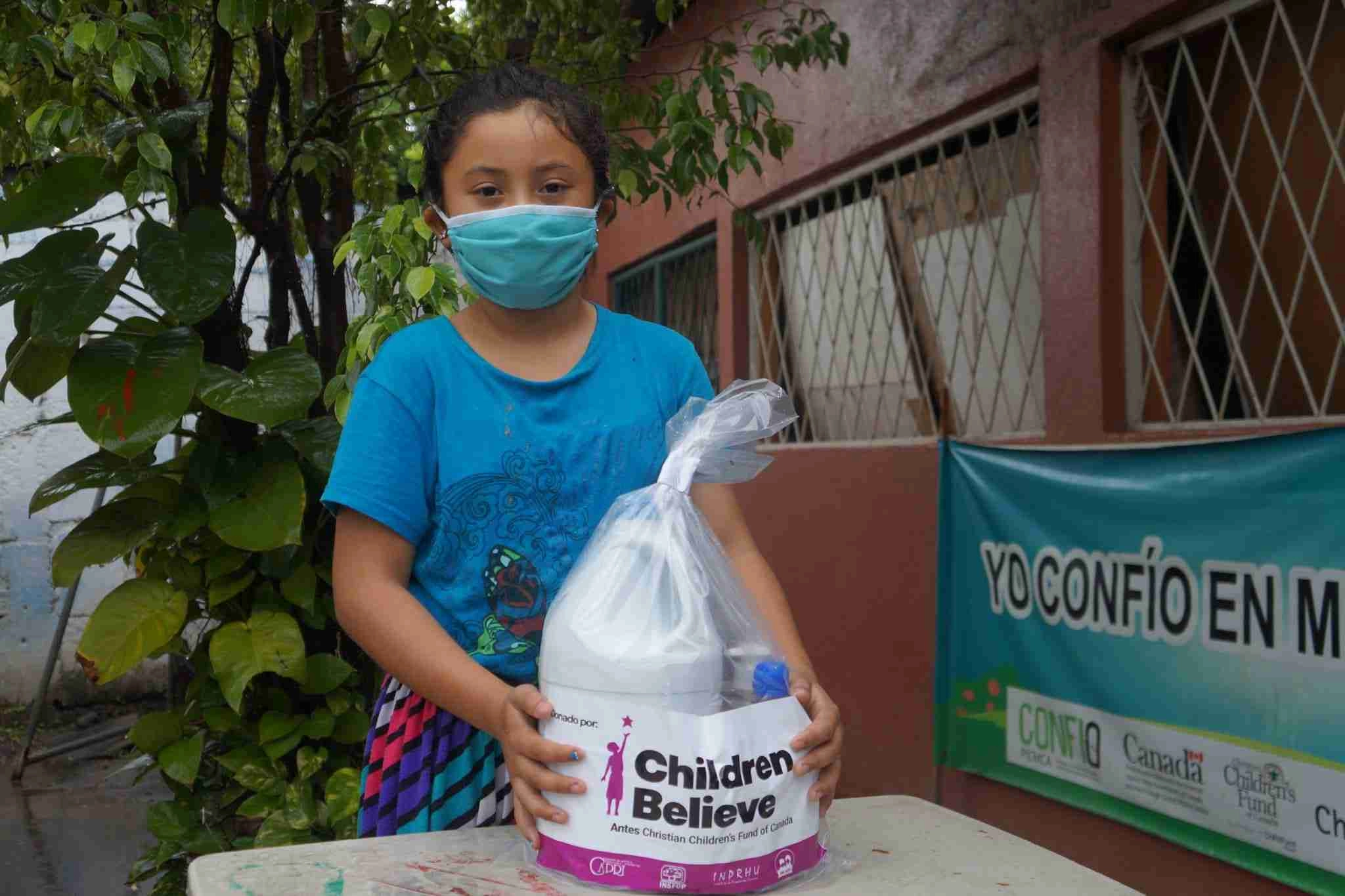 Girl wearing mask with covid essentials bag from children pack